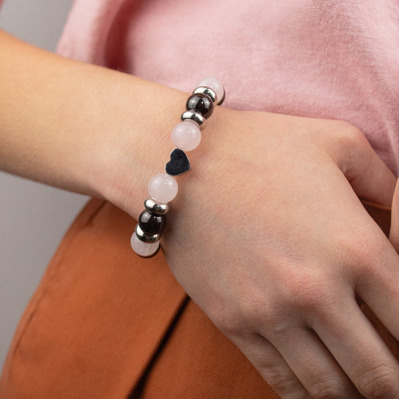 Women's bracelet featuring natural Quartz Rose and Almandine Garnet stones. Women's bracelet featuring natural Quartz Rose and Almandine Garnet stones.