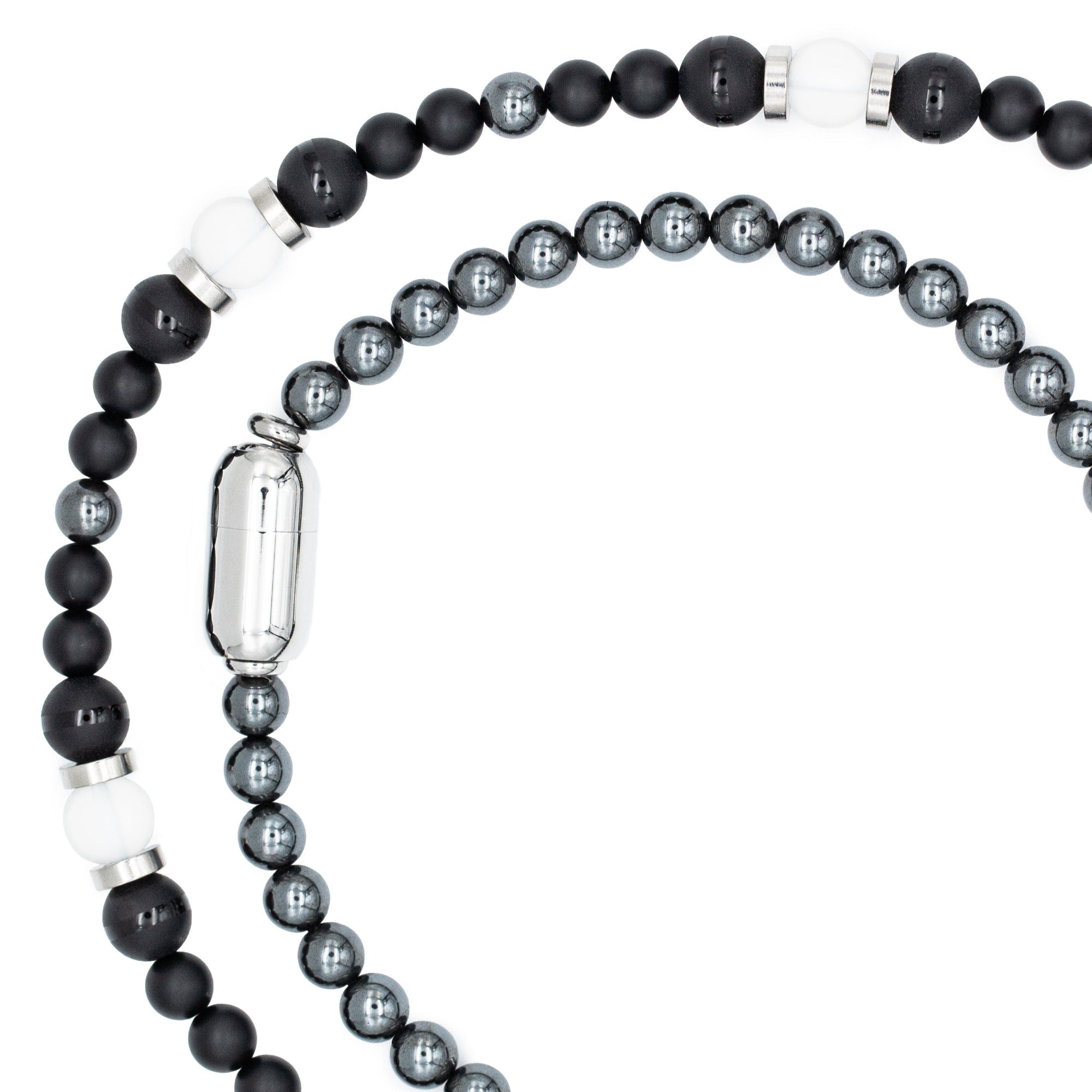 Modern men’s necklace featuring Onyx, Clear Quartz, and Hematite stones, shown on model, blending resilience with everyday sophistication. Modern men’s necklace featuring Onyx, Clear Quartz, and Hematite stones, shown on model, blending resilience with everyday sophistication.
