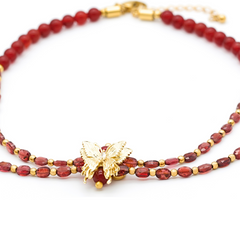 Close-up of butterfly charm with CZ on garnet and carnelian necklace