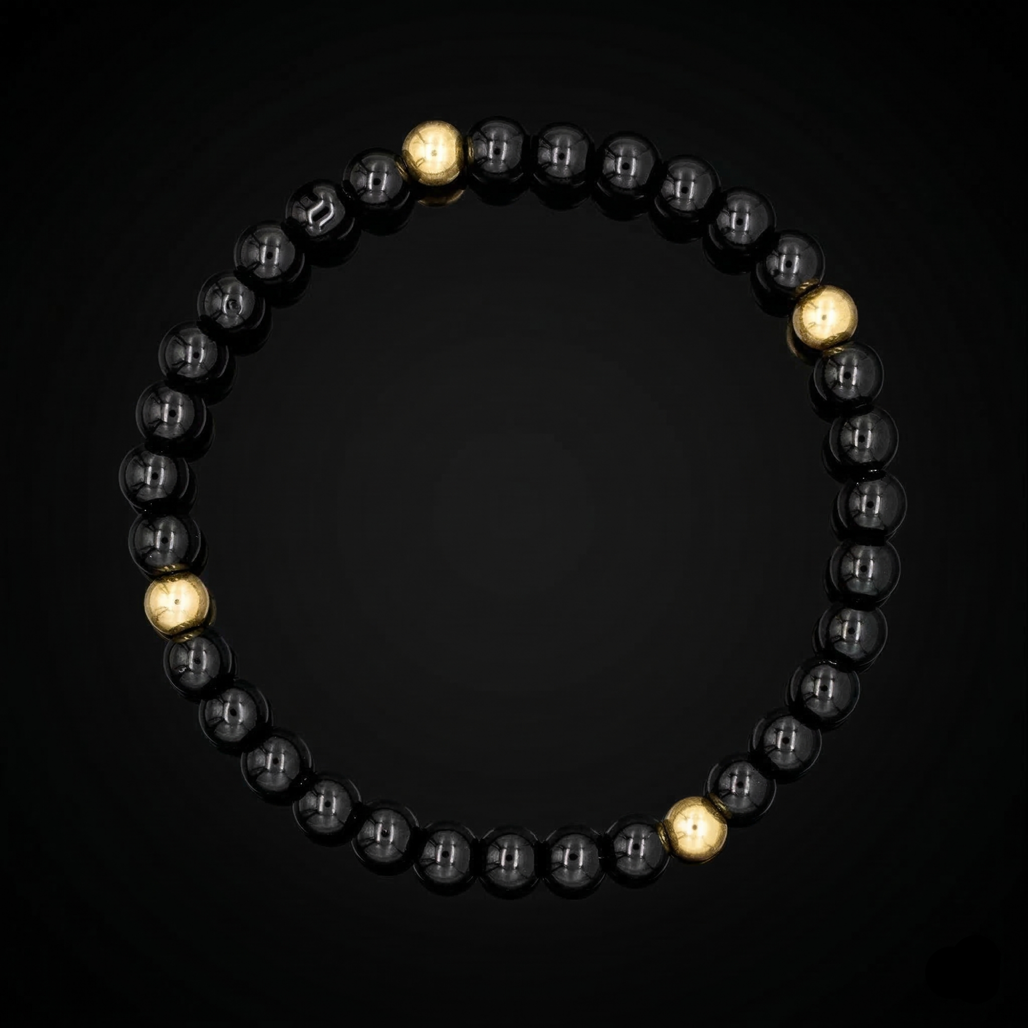 Close-up of polished 6mm black onyx beads with gold highlights