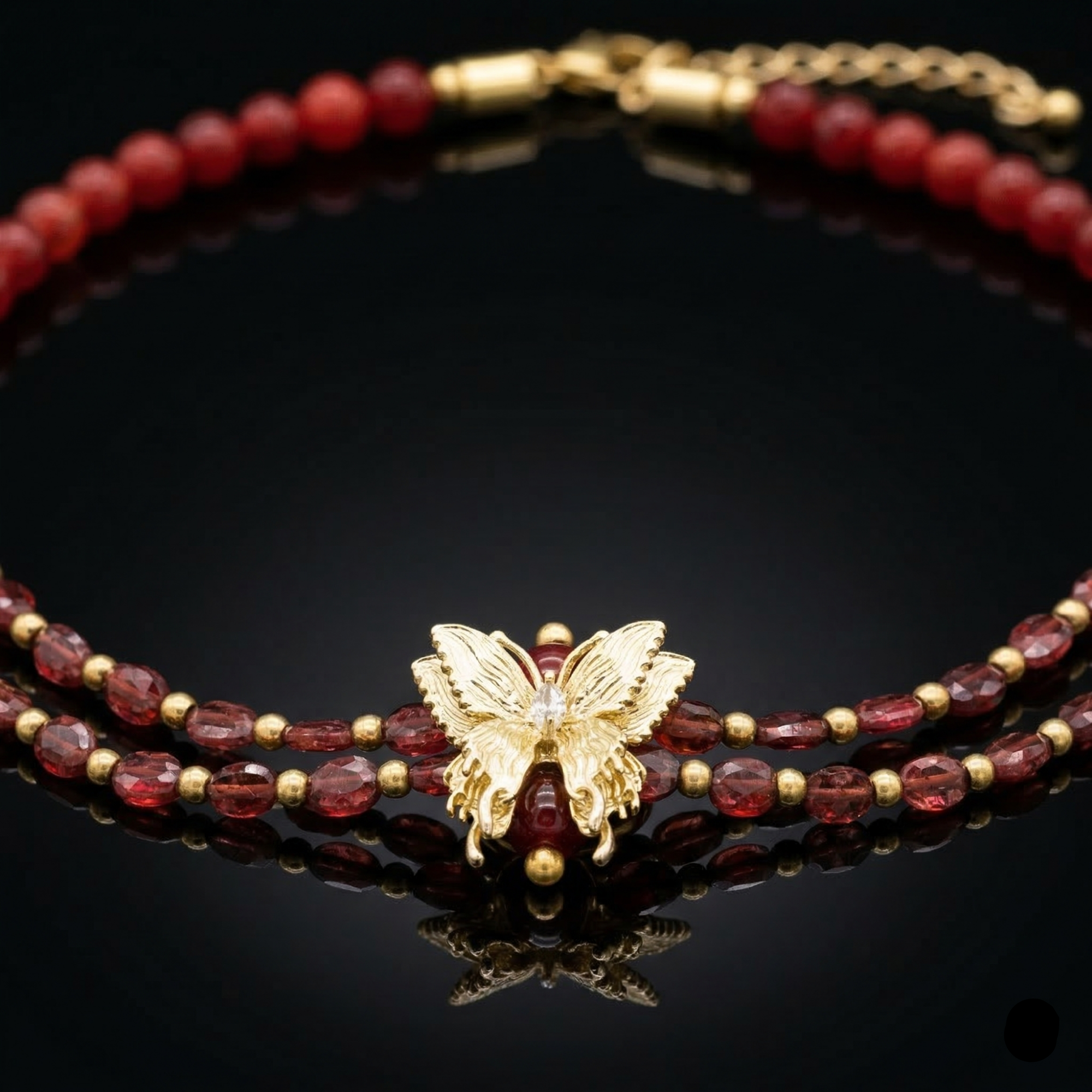 Close-up of butterfly charm with CZ on garnet and carnelian necklace