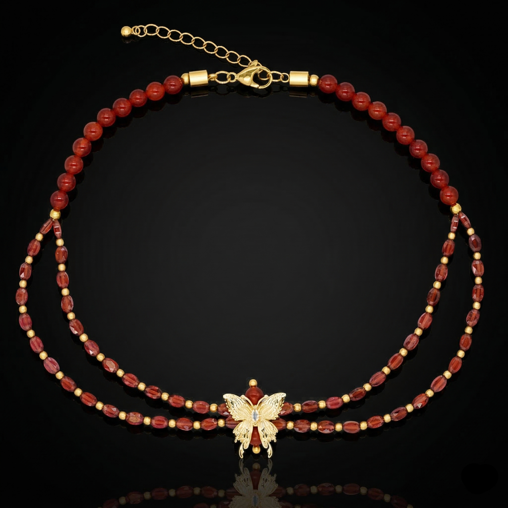 Woman wearing red gemstone necklace with butterfly pendant