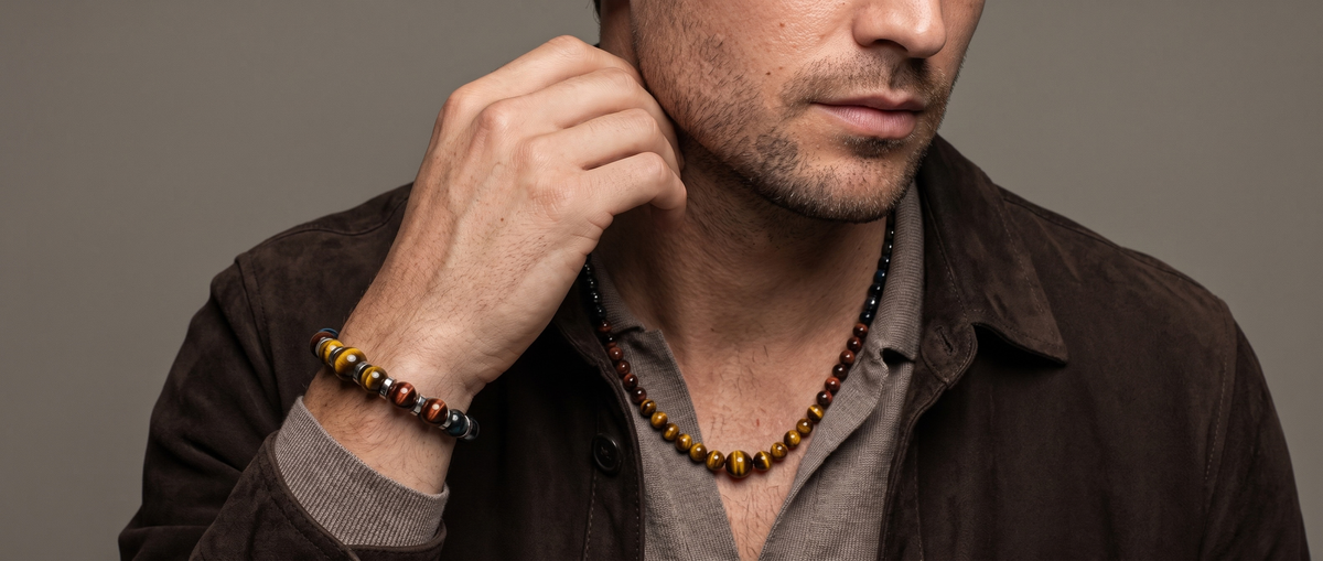 Man wearing an Alfabeads beaded necklace and matching bracelet with a brown jacket.