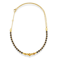 Close-up of smoky quartz and citrine beads in men's gold necklace