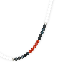 Close-up of white agate, blue tiger eye, and carnelian beads in women's choker