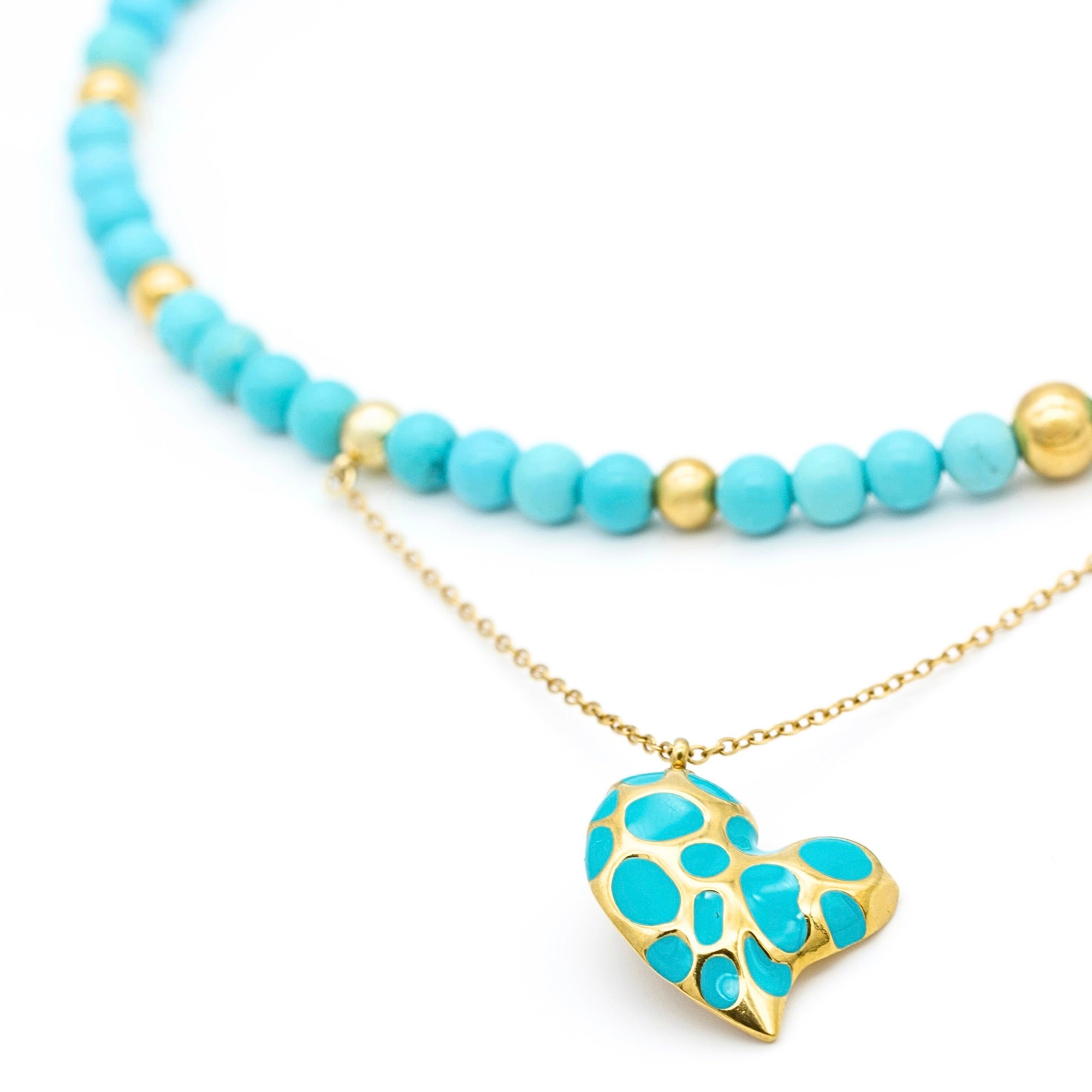 Close-up of turquoise beads in women's choker necklace with heart pendant