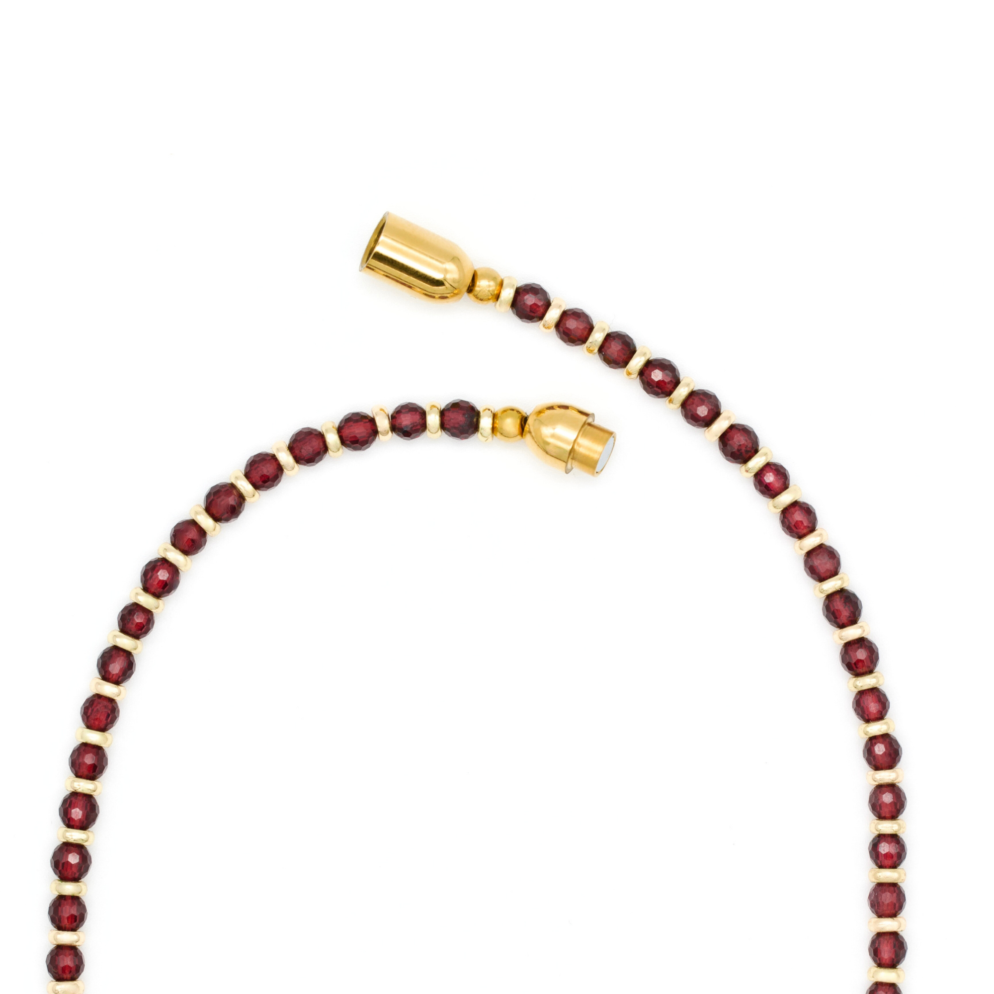 energy jewelry for women – garnet and evil eye necklace close-up