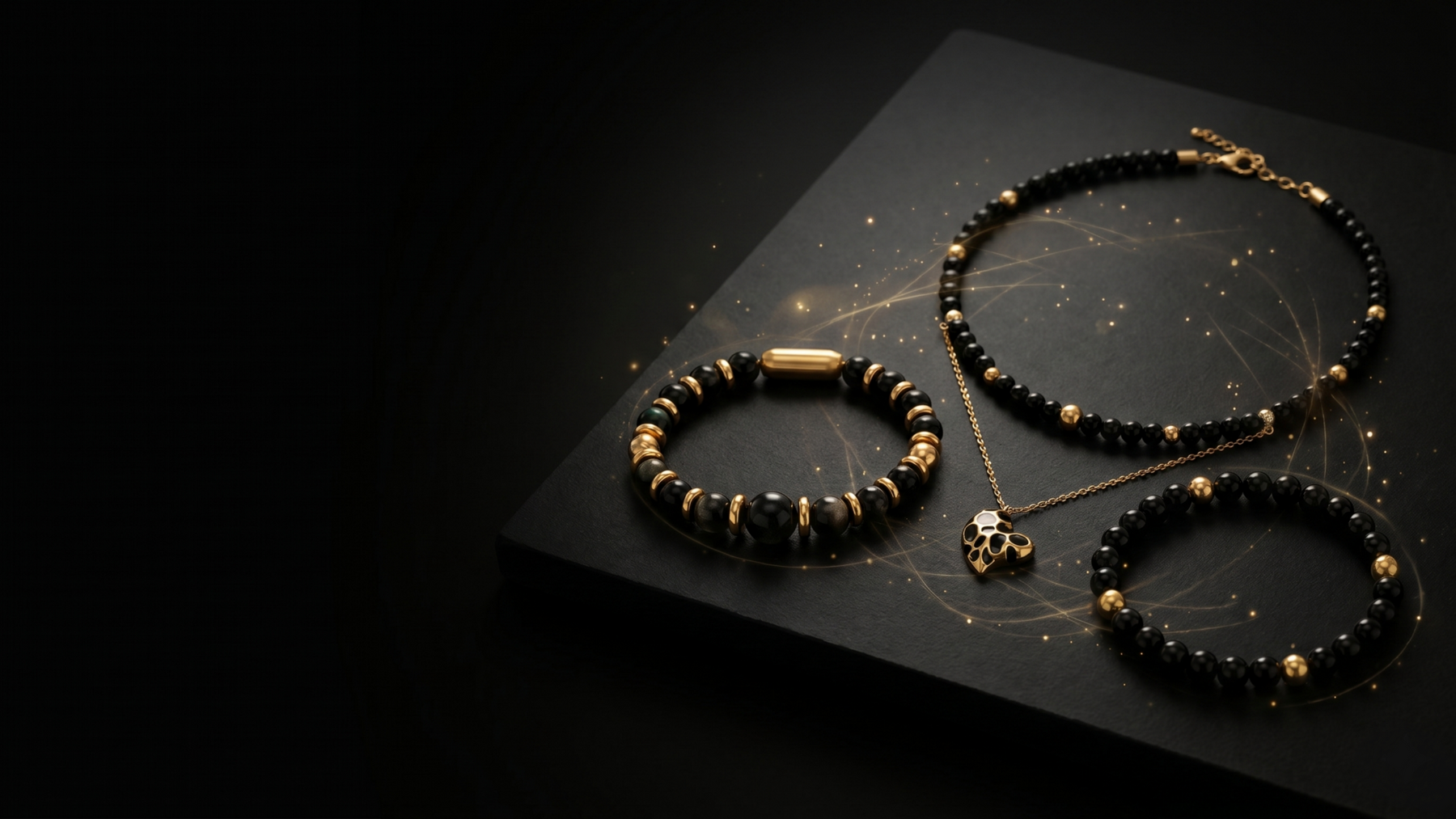 Black and gold natural stone jewelry by alfabeads on a dark surface with subtle golden energy lines