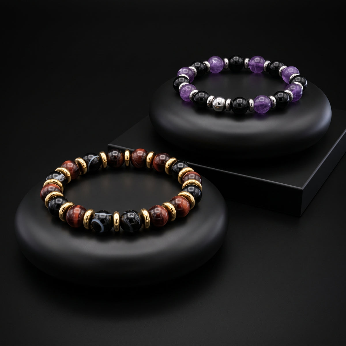 Two ALFABEADS gemstone bracelets on black display stands
